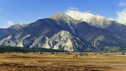 Snow-Dusted Peak Above the Valley Floor — Matthew Satchell